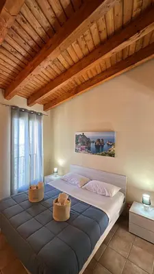 a bedroom with a large bed with two baskets on it at Domus Mea Apartments in Carini