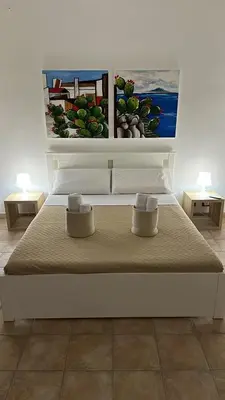 a bed with two pillows on it in a room at Domus Mea Apartments in Carini