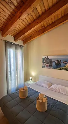 a bedroom with a large bed with two baskets on it at Domus Mea Apartments in Carini