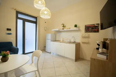 a kitchen and living room with a table and a dining room at RelaxTime Casa Vacanze in Palermo