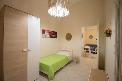 a bedroom with a green bed in a room at RelaxTime Casa Vacanze in Palermo