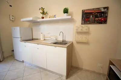 a kitchen with a sink and a refrigerator at RelaxTime Casa Vacanze in Palermo