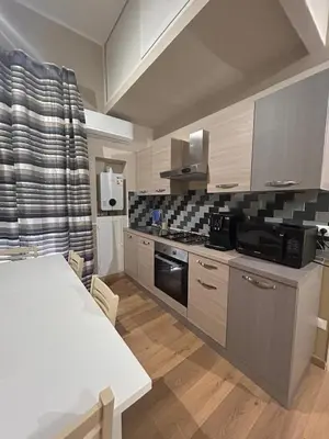 a kitchen with a table and a stove top oven at Emanuela Home in Palermo