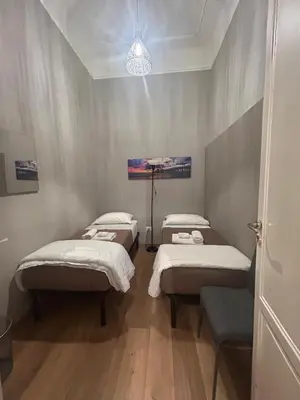 a room with three beds in a room at Emanuela Home in Palermo