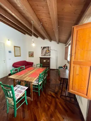 a dining room with a table and green chairs at House Quattro Canti in Palermo