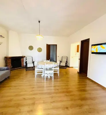 a living room with a white table and chairs at Villetta Verde Mare - Scopello in Scopello