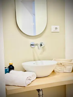 a bathroom with a white sink and a mirror at Sicilia biedda casa vacanze in Terrasini