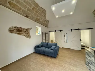 a living room with a blue couch and a wall at Sicilia biedda casa vacanze in Terrasini