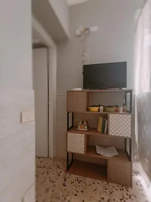 a television on a shelf in a room at Gioiello di casa in Palermo