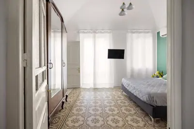 a bedroom with a bunk bed with purple sheets at La Castellana Apartments, vista panoramica sul mare, nel cuore storico di Carini, a due passi dal Duomo e dal castello in Carini