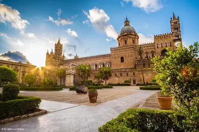 a large building with a clock tower on top of it at A Casa Tua Palermo in Palermo