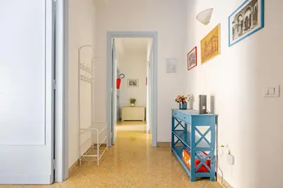 a hallway with a blue dresser and a blue table at AL Qanat di Notarbartolo in Palermo