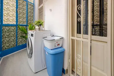 a bathroom with a washing machine next to a door at AL Qanat di Notarbartolo in Palermo
