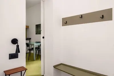 a hallway with a door leading into a room with a table at Azizò in Palermo