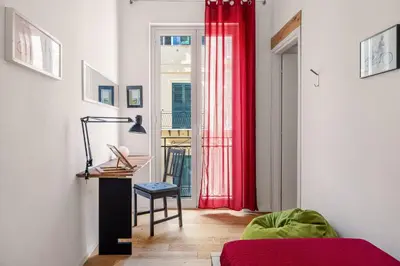 a living room with red curtains and a red couch at Azizò in Palermo