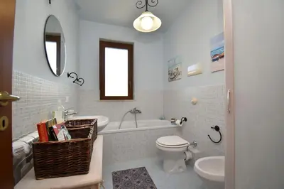 a bathroom with a toilet and a tub and a sink at Casa Carini - Villa Vacanze sul Mare con piscina idromassaggio in Carini