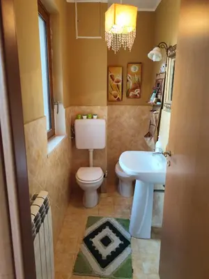 a bathroom with a toilet and a sink at Casa Carini - Villa Vacanze sul Mare con piscina idromassaggio in Carini