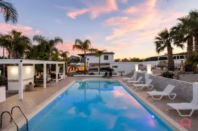 a swimming pool with lounge chairs and a resort at Amazing Villa with pool & Jacuzzi in Balestrate