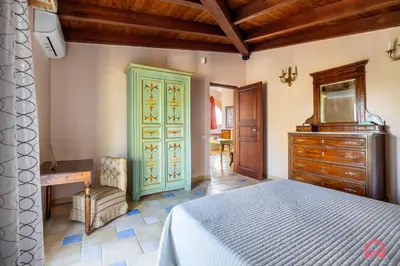 a bedroom with a bed and a desk and a dresser at Amazing Villa with pool & Jacuzzi in Balestrate