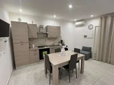 a kitchen and dining room with a table and chairs at Ginevra House in Palermo