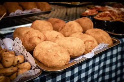 a table with a tray of pastries and other foods at Ginevra House in Palermo