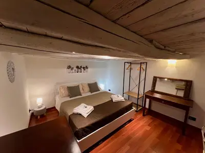a bedroom with a bed and a mirror and a piano at Sisidda Home in Palermo