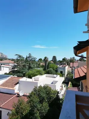 a view of a city with white buildings and trees at apartment by the sea Mondello beach in Palermo