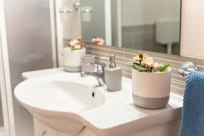 a bathroom with a sink with flowers on it at Appartamenti Bellini in Castellammare del Golfo