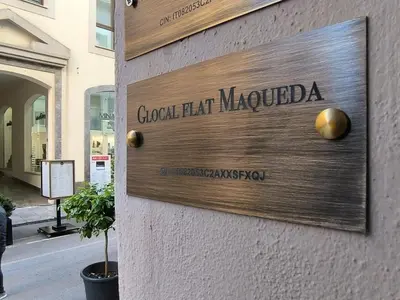 a sign on the side of a building at Glocal flat Maqueda in Palermo