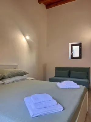 a bedroom with a bed with two towels on it at Chicca House in Palermo