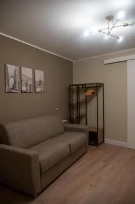 a living room with a couch and a ceiling fan at Prestige in Palermo