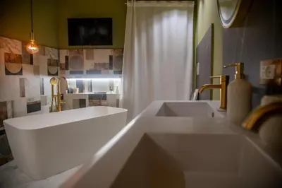 a white bathroom with two sinks and a mirror at Prestige in Palermo