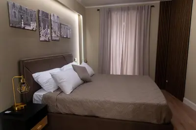 a small bedroom with a bed with white pillows at Prestige in Palermo