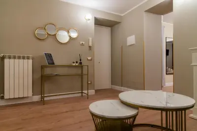 a room with two tables and two mirrors on the wall at Prestige in Palermo