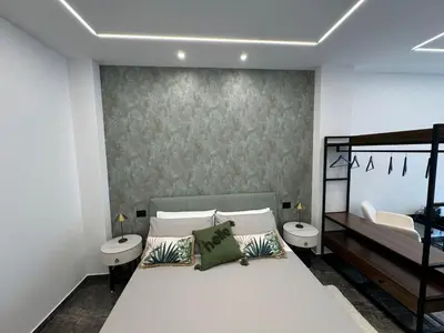 a bedroom with a bed and two sinks in it at GRA' Suite Deluxe in Terrasini