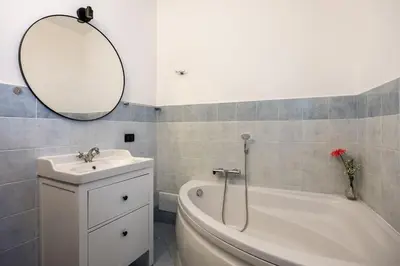 a bathroom with a sink and a tub and a mirror at Vista San Domenico in Palermo