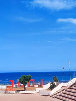 a group of stairs leading to the beach with the ocean at Azzurra in Terrasini