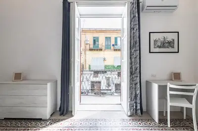 an open door into a room with a desk and a window at GuestHost - La Dimora dei Mille - Roomy Apartment with Terrace in Palermo