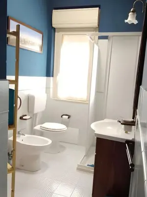 a bathroom with a toilet and a sink and a window at Casa delle Stelle in Scopello