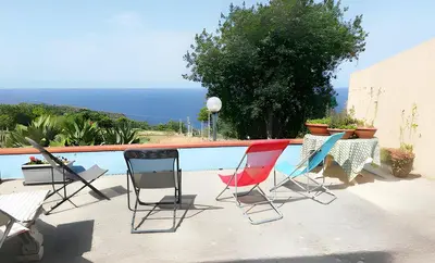 a group of chairs sitting next to a swimming pool at Casa delle Stelle in Scopello