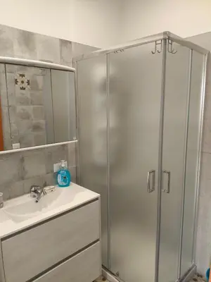 a bathroom with a shower and a sink at Home For You in Carini