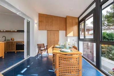 a kitchen and living room with a table and chairs at Villa Makar Seaview in Macari