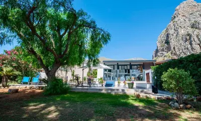 a house with a large tree in the yard at Villa Makar Seaview in Macari
