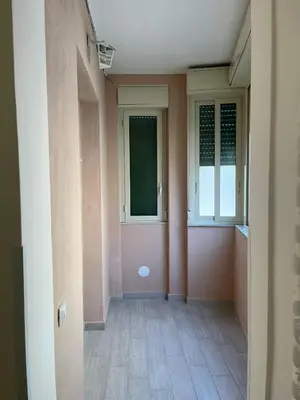 an empty hallway with a door and windows at La casa di Gabri in Palermo