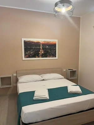 a bedroom with a bed with a picture of the eiffel tower at La casa di Gabri in Palermo