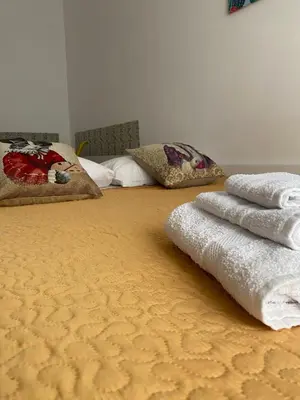 a bed with towels sitting on top of it at La Casetta sul Corso in Palermo
