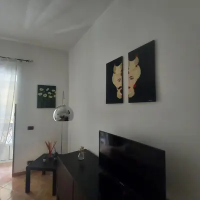 a living room with two paintings of cats on the wall at La Casetta sul Corso in Palermo