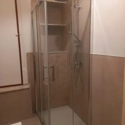 a shower with a glass door in a bathroom at La Casetta sul Corso in Palermo