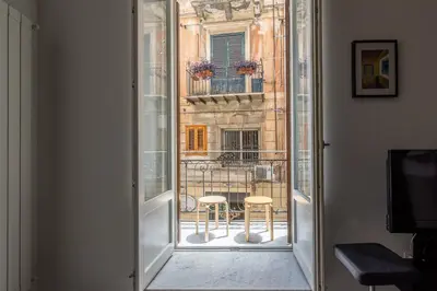 an open door with a view of a balcony at MetaM Apartment in the City Center by Wonderful Italy in Palermo