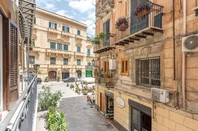an alley in an old city with buildings at MetaM Apartment in the City Center by Wonderful Italy in Palermo